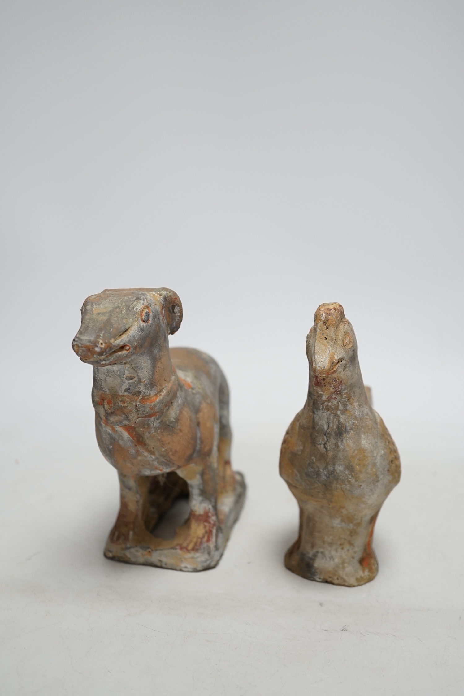 Two Chinese pigment painted figures of a cockerel and a dog, Han dynasty or later, 17cm